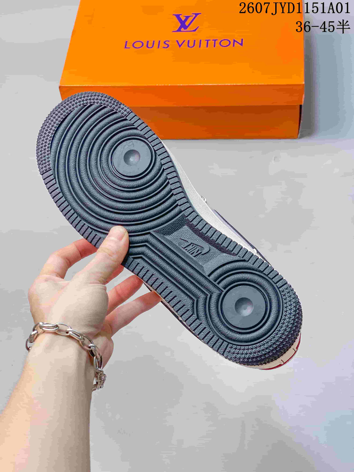 Close-up of the dark treaded outsole with circular traction details; orange box in the background.