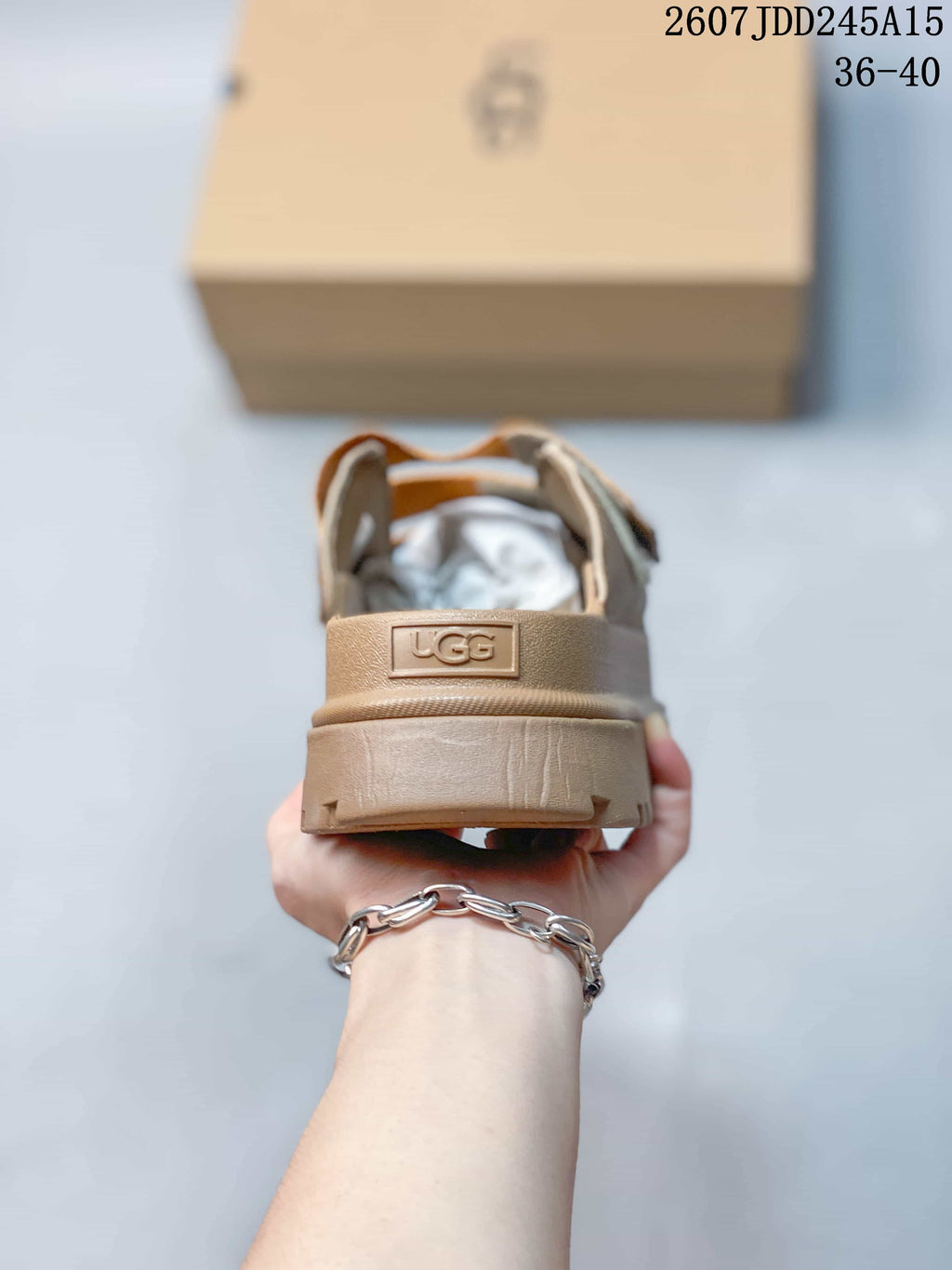 Rear view of the tan platform sandal showing the raised heel and UGG heel badge.