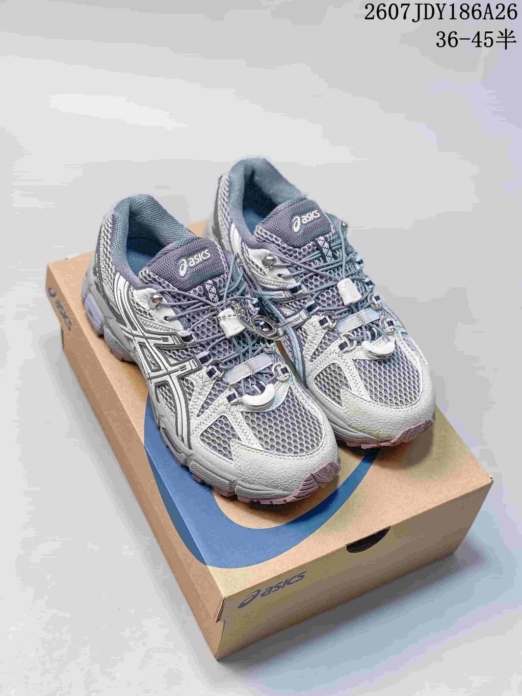 Pair of gray and white ASICS Gel-Kahana 8 FL sneakers displayed on an ASICS shoebox, with style code 2607JDY186A26 and size range 36–45 shown at the top.