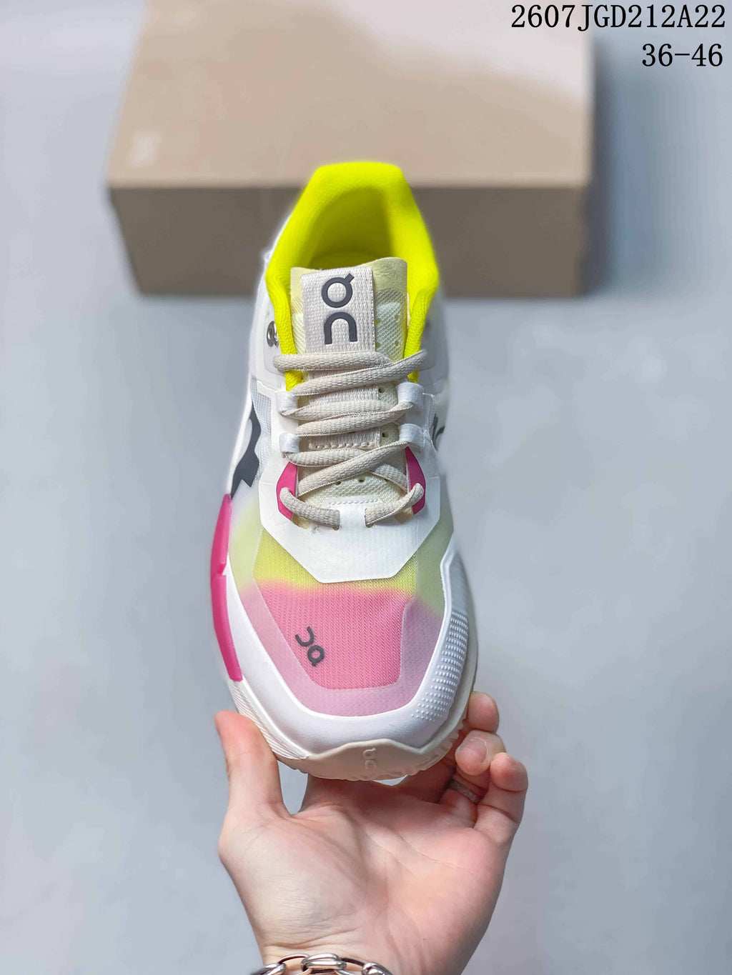 Top view showing the white laces, neon yellow collar lining and pink-to-yellow forefoot color treatment.