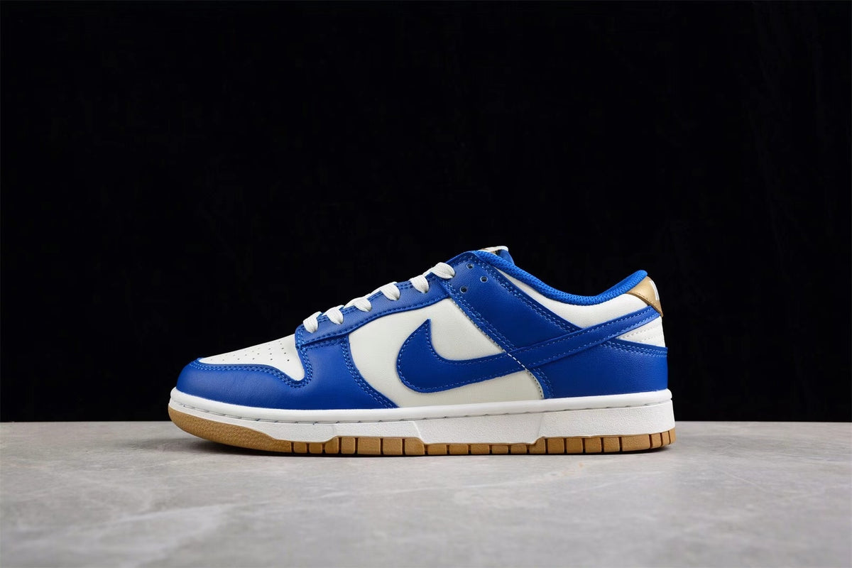 Opposite side profile of the white and blue low-top sneaker showing the blue Swoosh and gum outsole.
