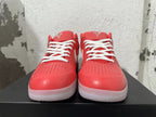 Front view of pink Nike Kobe shoes with white laces and perforated toe panels.