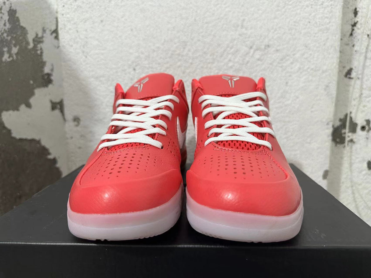 Front view of pink Nike Kobe shoes with white laces and perforated toe panels.