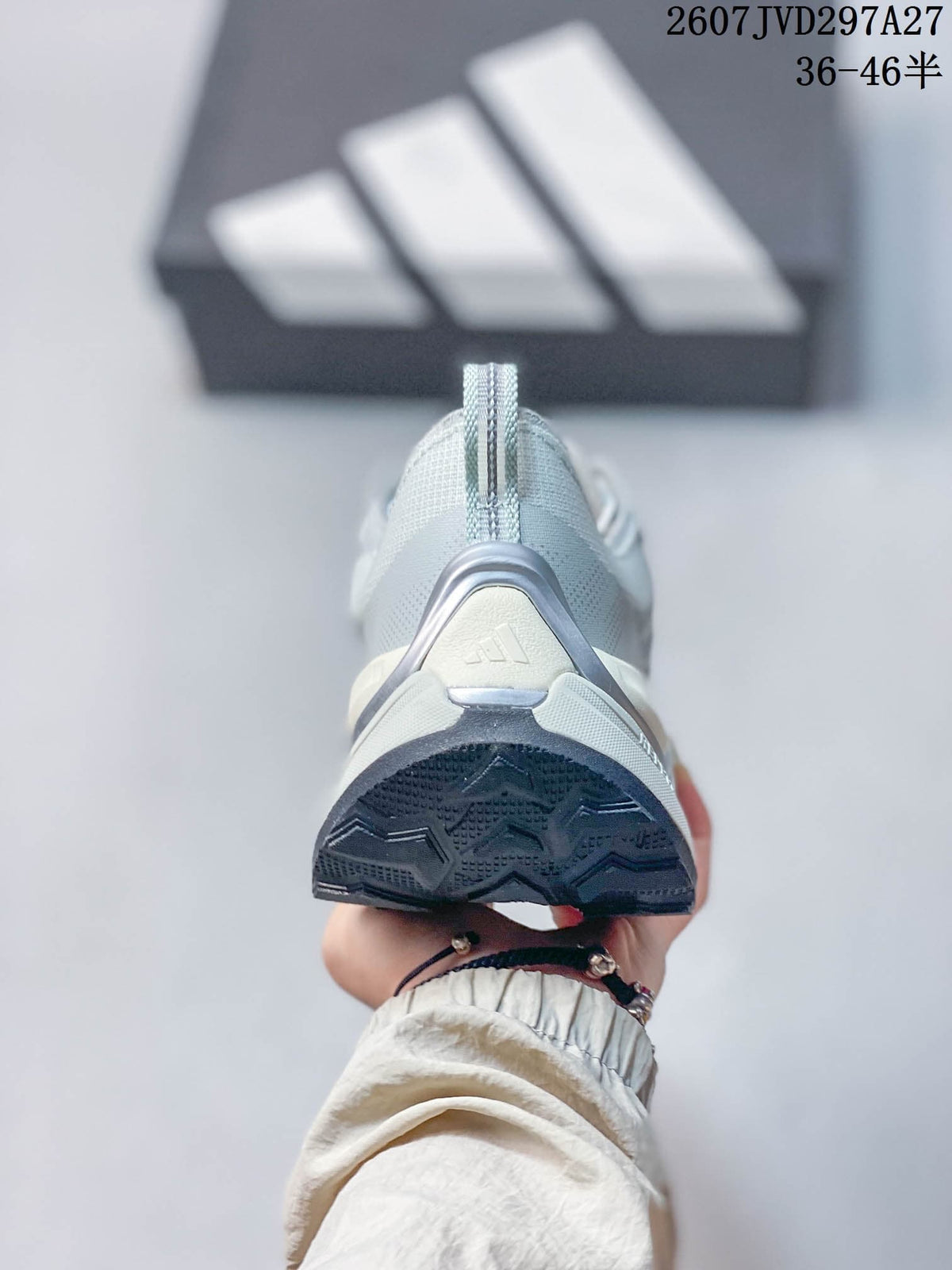 Rear view showing the padded heel, pull tab, adidas logo, and dark outsole edge.