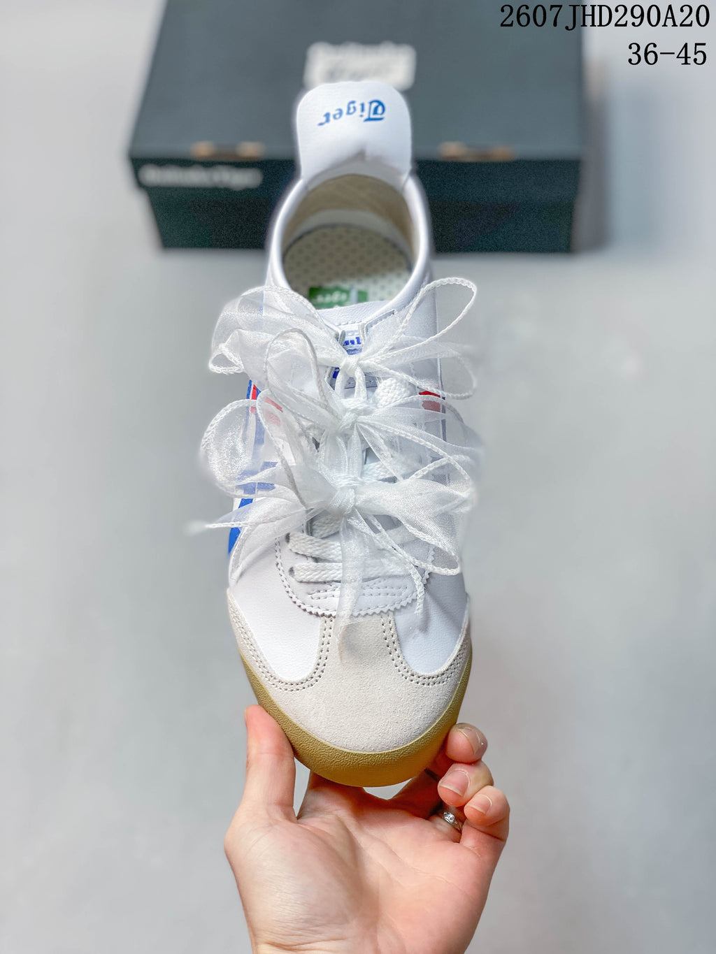 Top view showing the white upper, textured toe panels, and decorative ribbon laces.