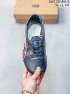 Top view showing the rounded toe, dark laces, layered side stripes, and branded insole.