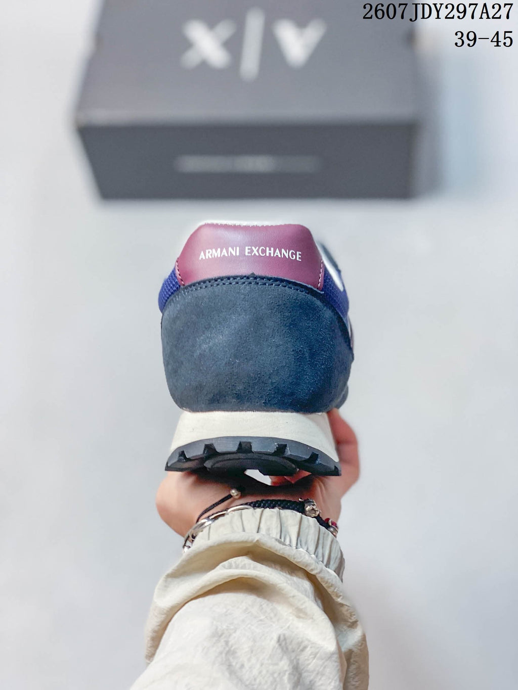 Rear view showing the burgundy heel tab, padded collar, cream midsole, and dark outsole.