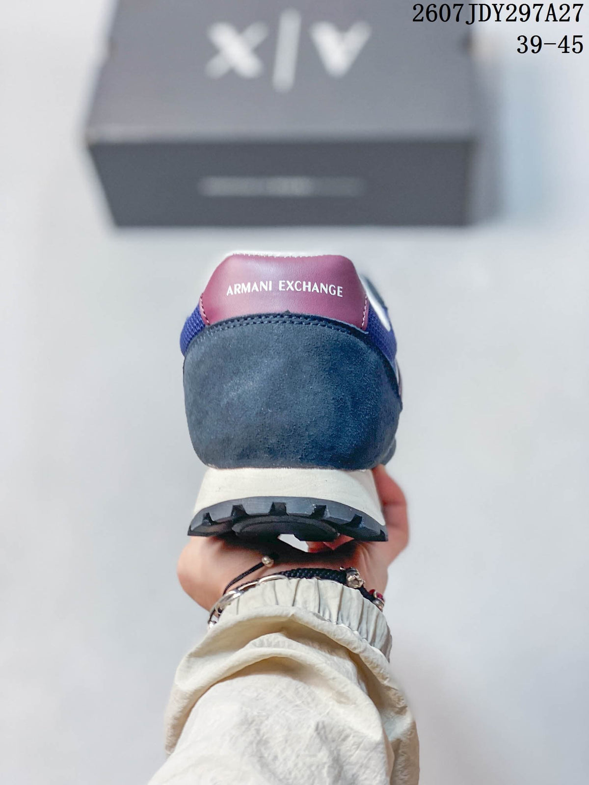 Rear view showing the burgundy heel tab, padded collar, cream midsole, and dark outsole.