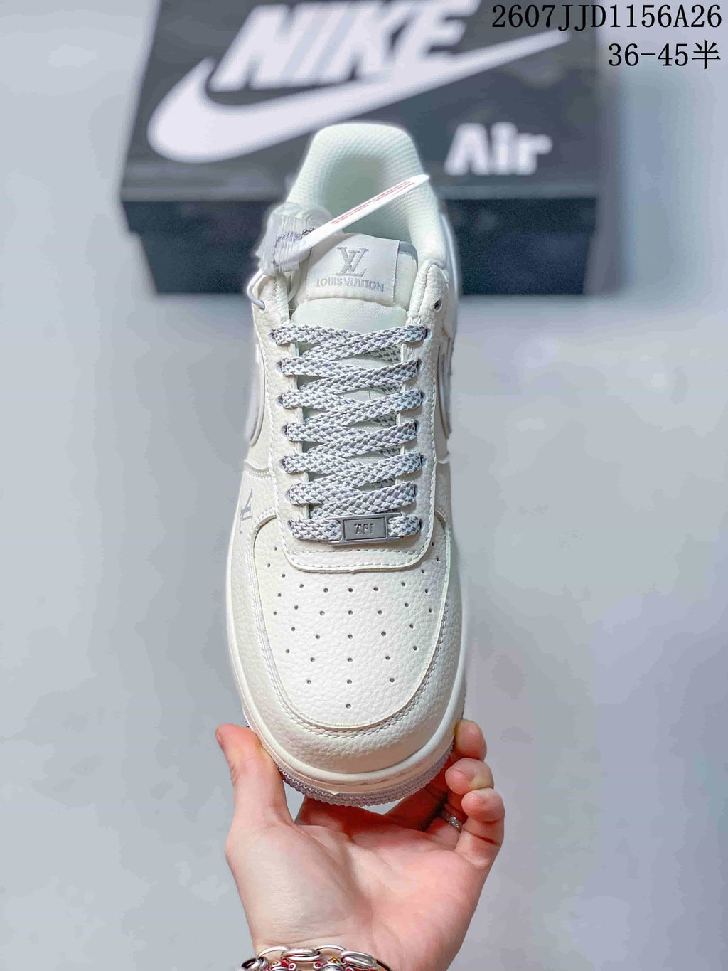 Top view showing the perforated toe box, grey patterned laces and branded tongue.