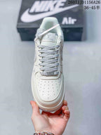 Top view showing the perforated toe box, grey patterned laces and branded tongue.