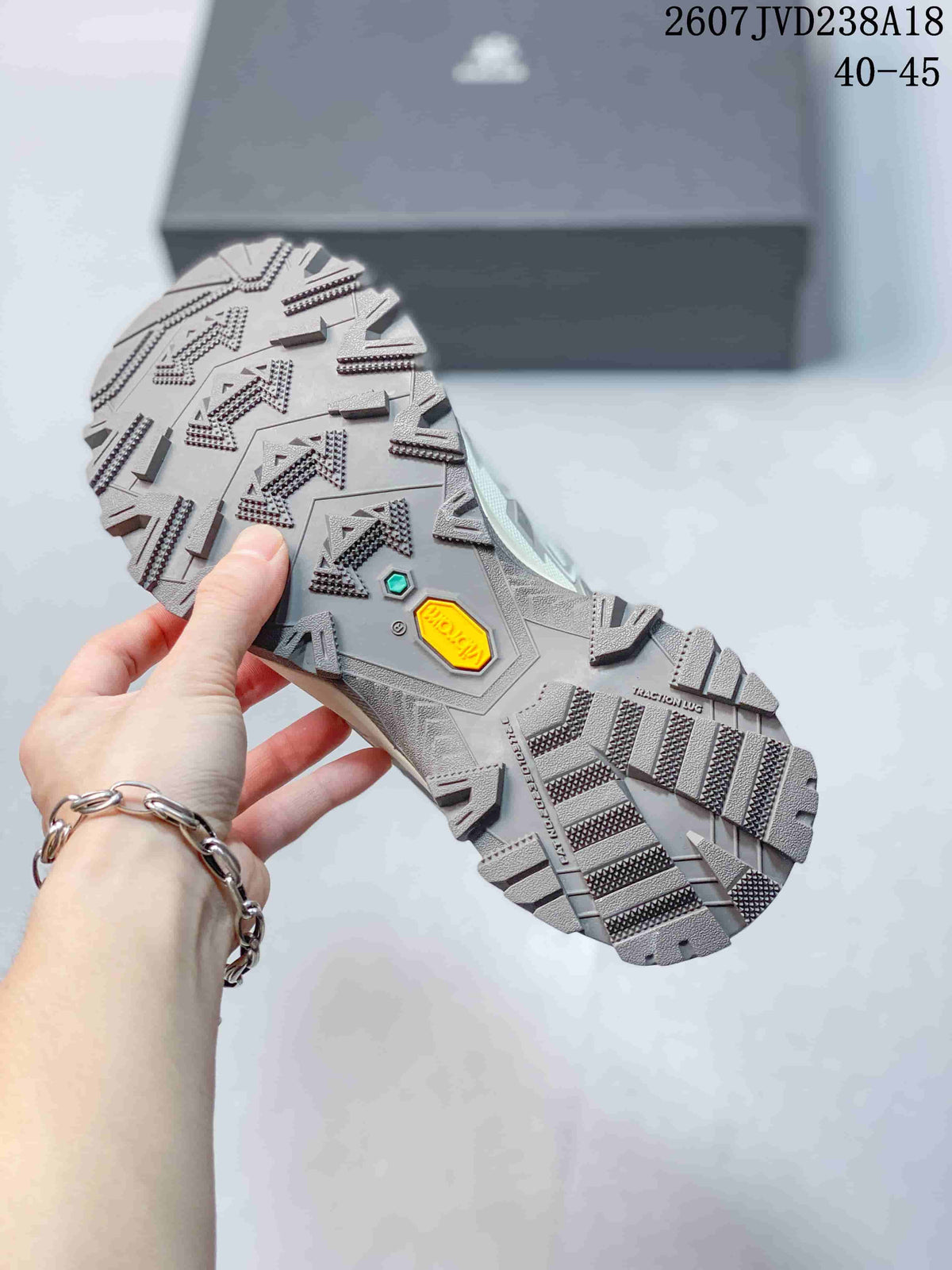 Close-up of the hiking shoe outsole showing directional lug patterns and colored outsole inserts.