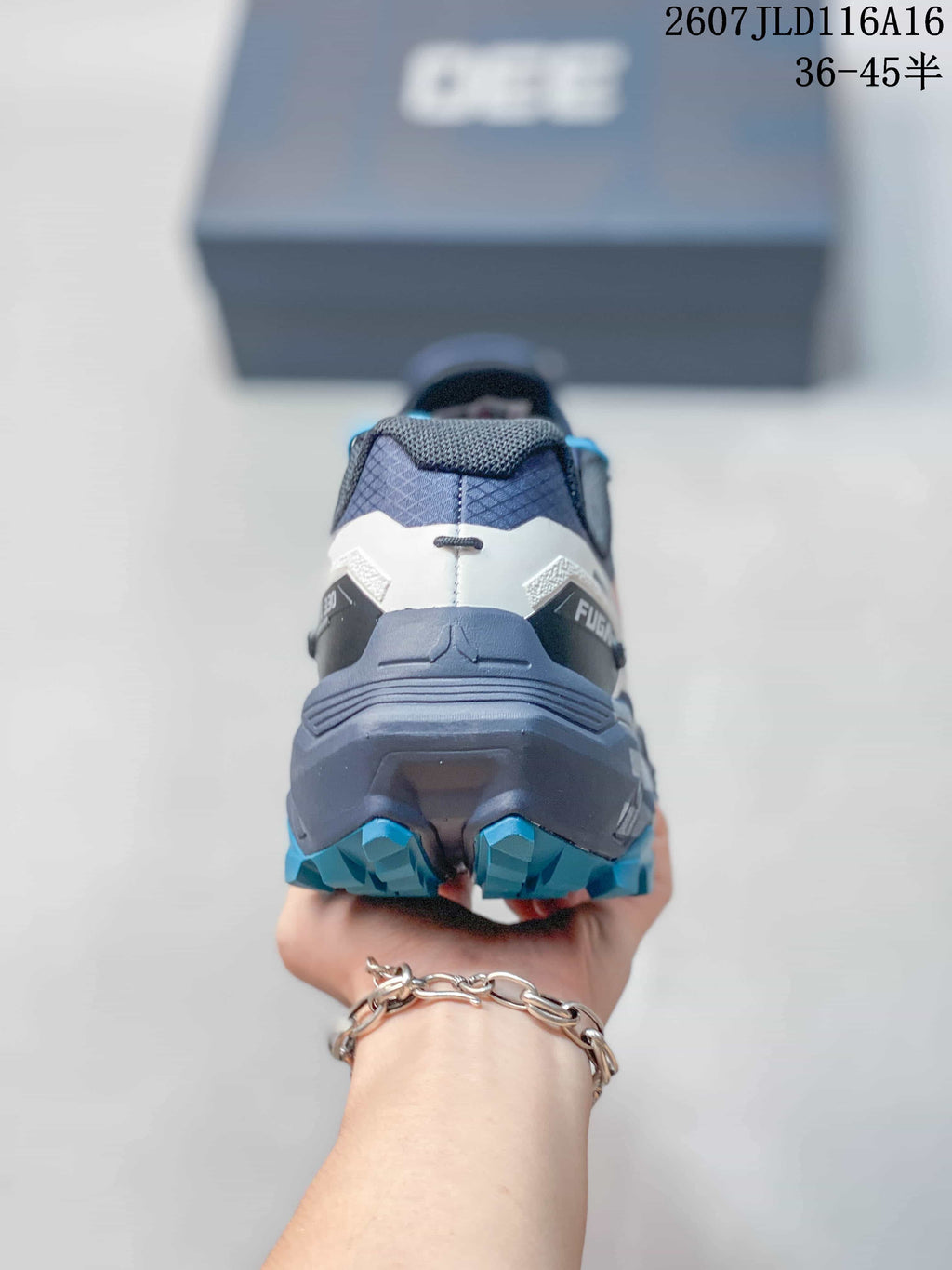 Rear view of the KAILAS FUGA EX330 shoe showing the structured heel and blue outsole lugs.