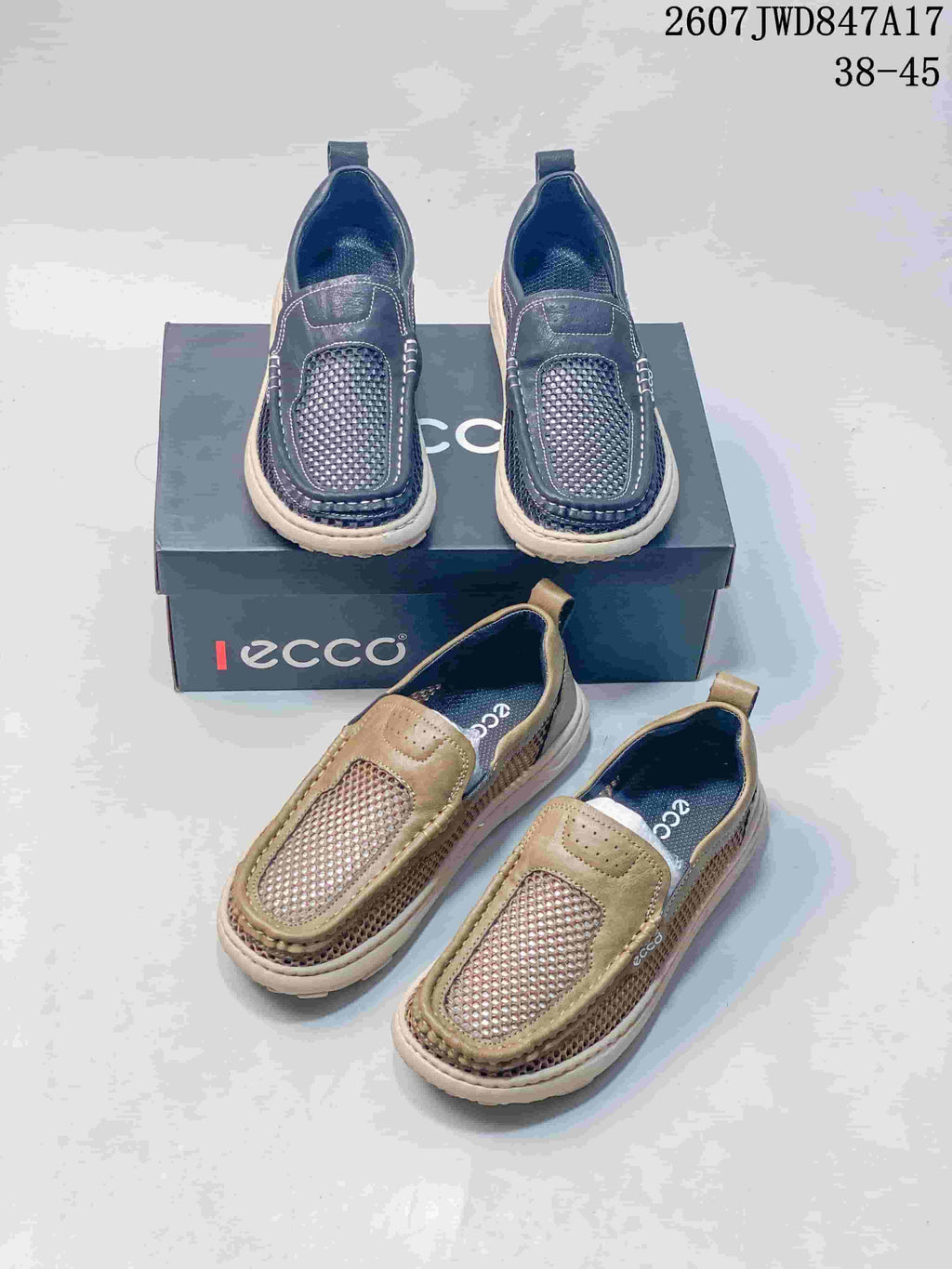 Dark navy and khaki ECCO slip-on shoes arranged together with an ECCO shoebox; image text shows style code 2607 JWD847A17 and size range 38–45.