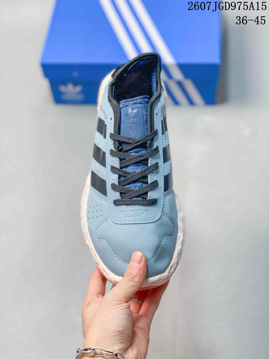 Top view of the low-top sneaker showing the rounded toe, dark laces, perforated side panel, and Adidas branding on the tongue.