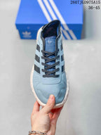 Top view of the low-top sneaker showing the rounded toe, dark laces, perforated side panel, and Adidas branding on the tongue.