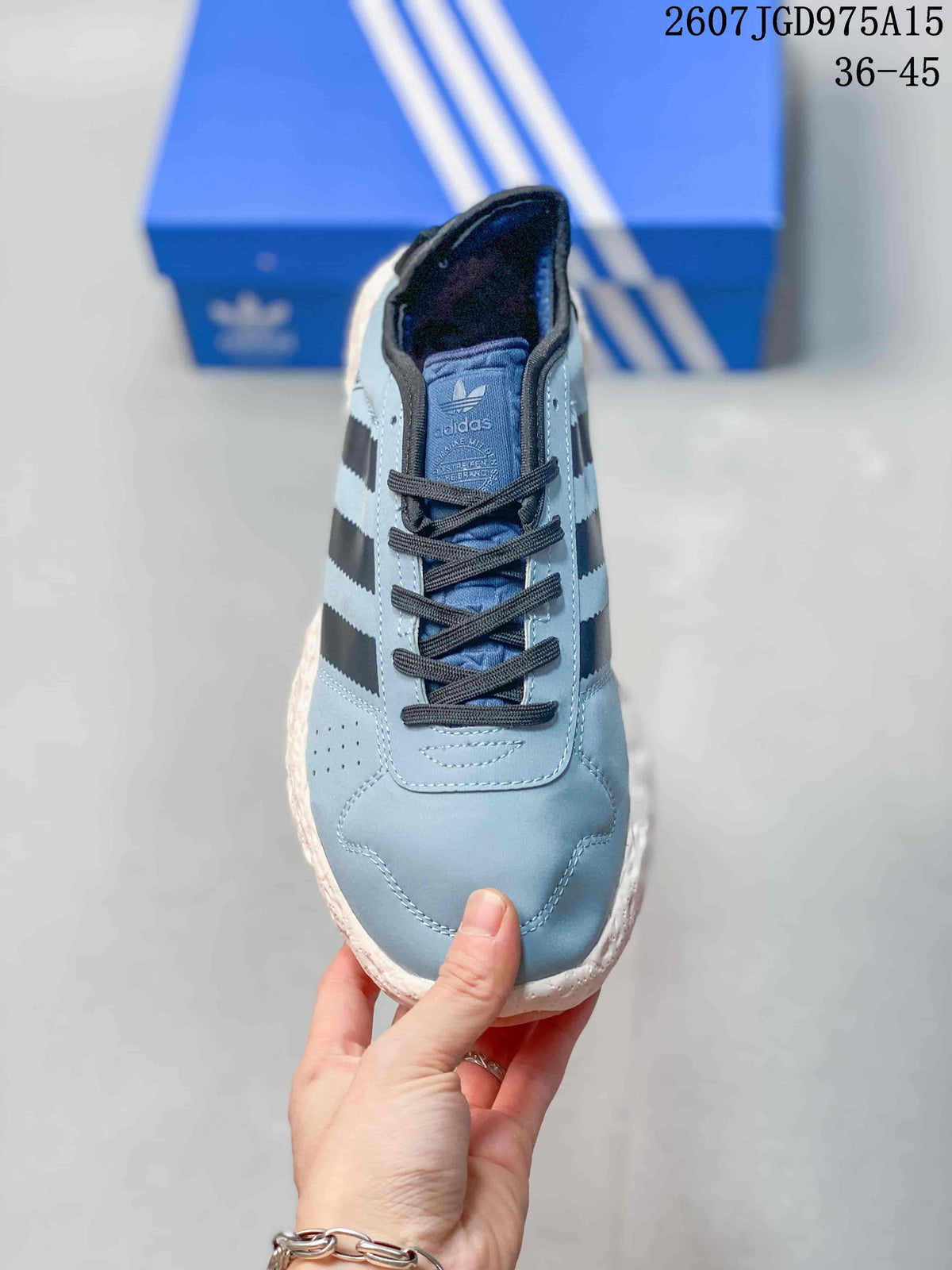 Top view of the low-top sneaker showing the rounded toe, dark laces, perforated side panel, and Adidas branding on the tongue.