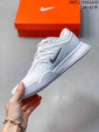 Side view showing the black Swoosh, white upper and textured outsole.