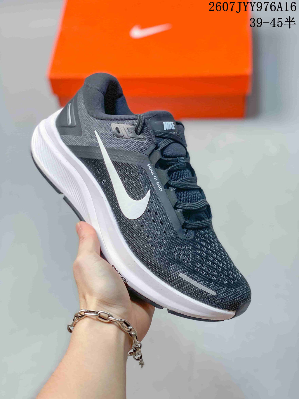 Angled side view showing the dark gray mesh upper, white Nike Swoosh, padded heel, and contrasting midsole.