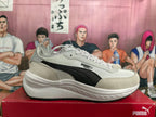 Side view of PUMA sneakers showing black side stripe and sculpted white midsole