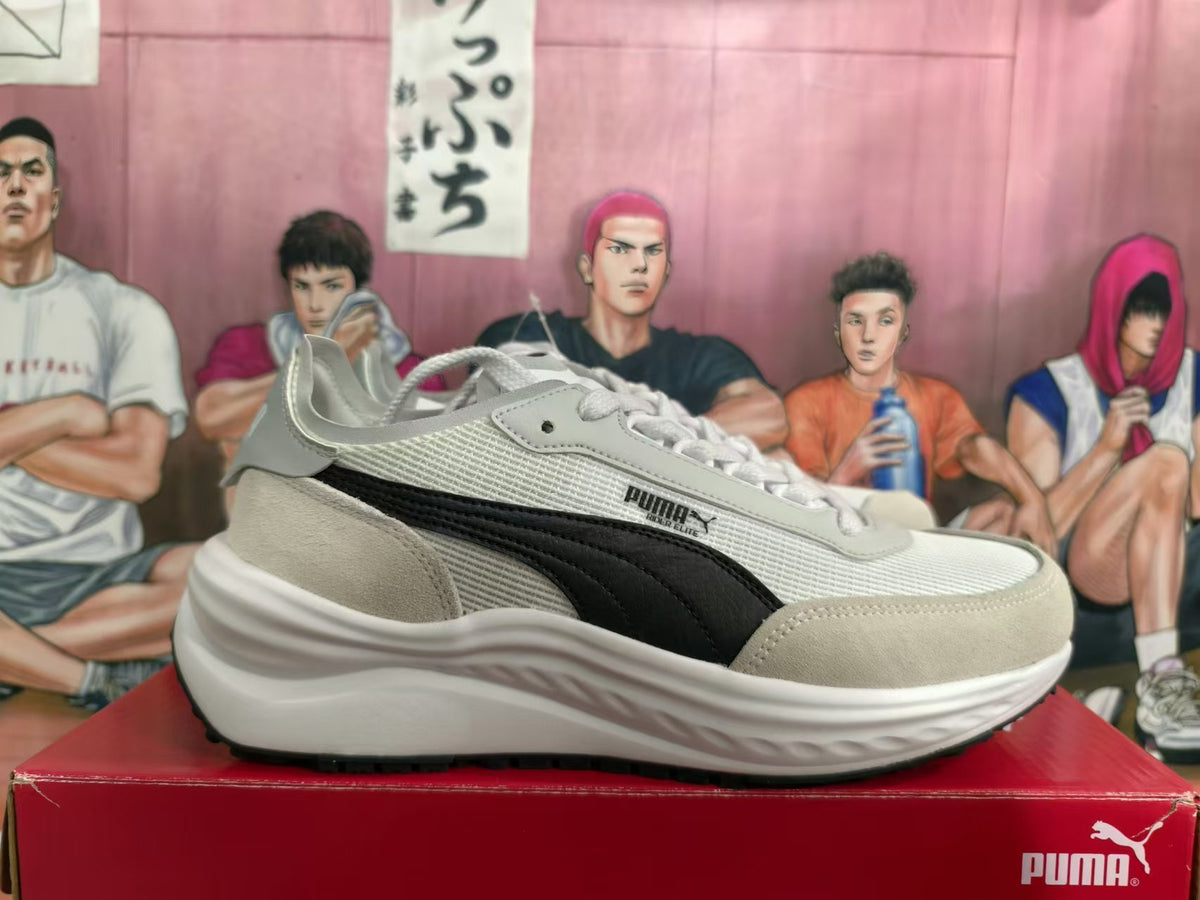 Side view of PUMA sneakers showing black side stripe and sculpted white midsole