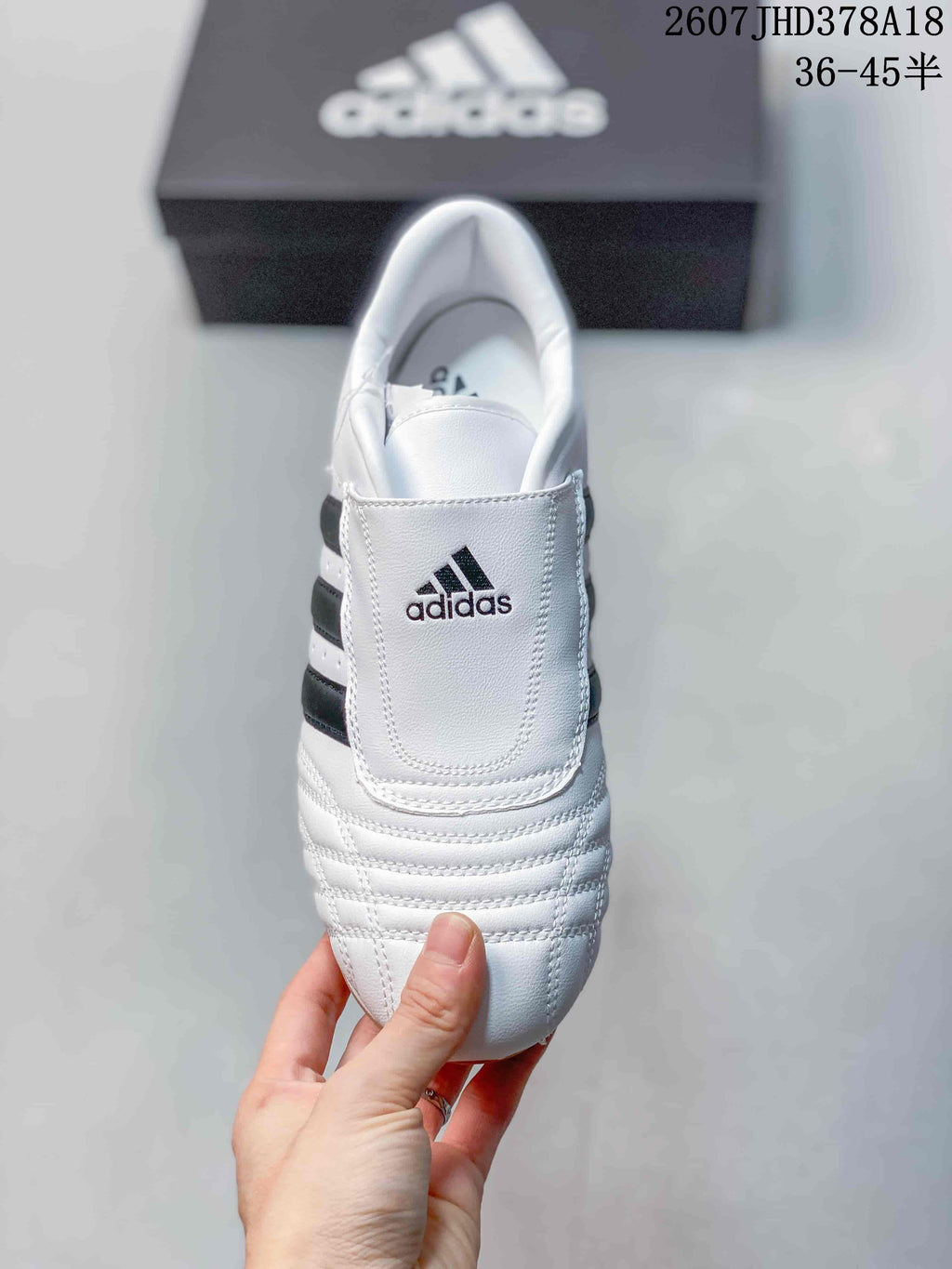 Top view of the sneaker showing the broad stitched tongue panel, adidas logo and padded collar.