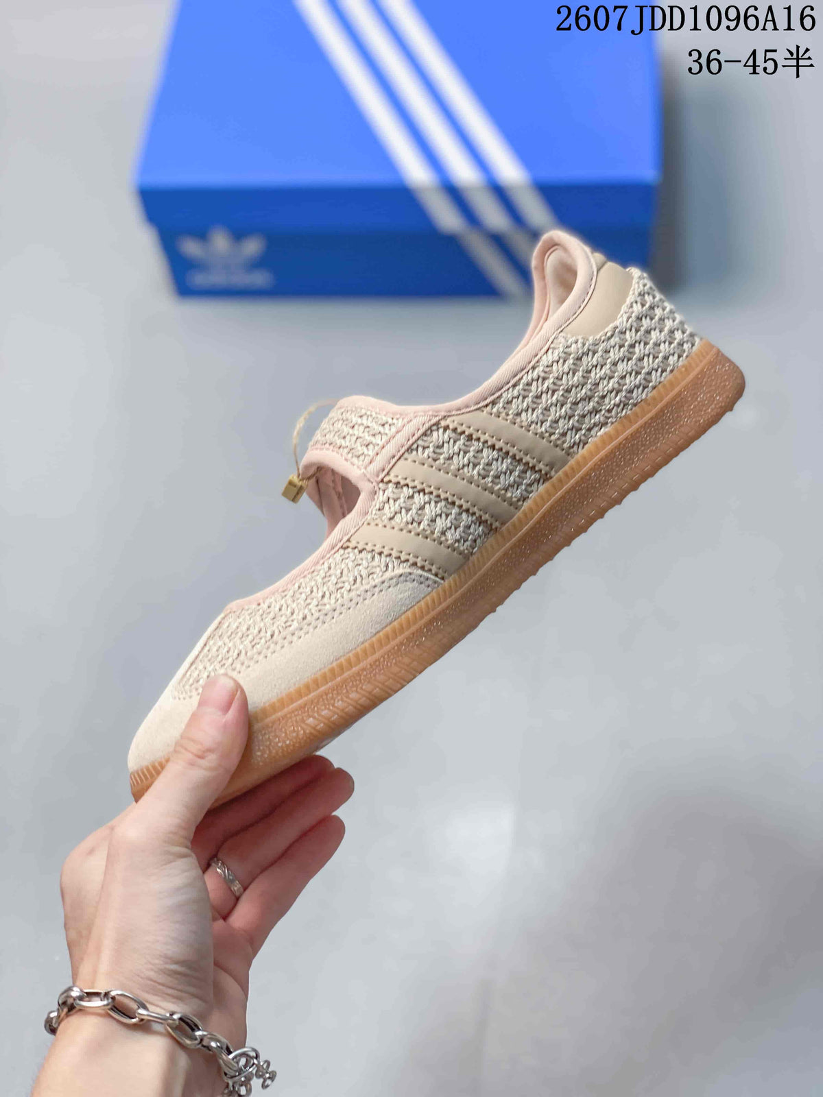 Side profile showing the beige woven upper, signature side stripes, hook-and-loop strap, and low gum sole.
