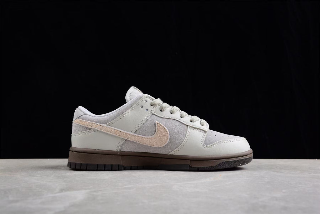 Side profile highlighting the low-top shape, gray panels, beige Swoosh and dark brown sole.