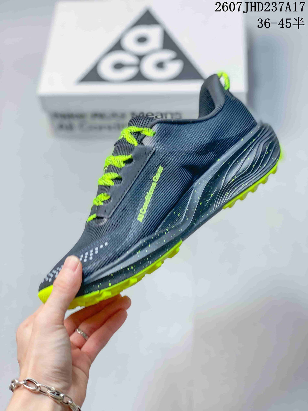Side profile highlighting the dark gray mesh-style upper, lime accents, and textured outsole.