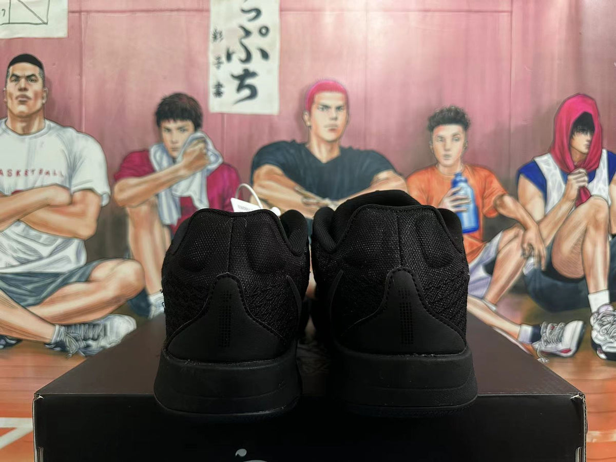 Rear view of a pair of black Nike basketball shoes