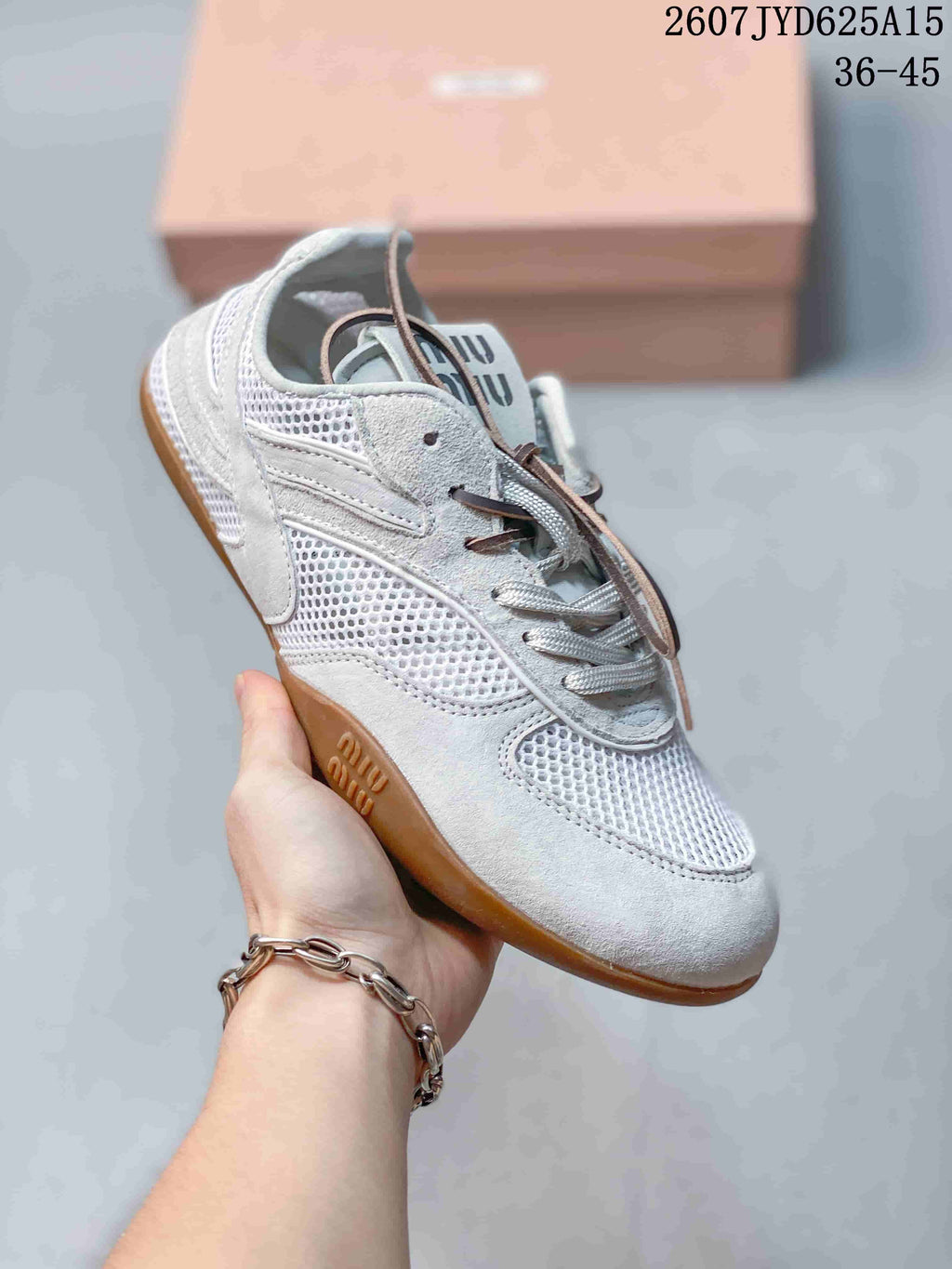 Angled side view of the sneaker showing its mesh panels, layered overlays, lace-up front, and gum-colored sole.