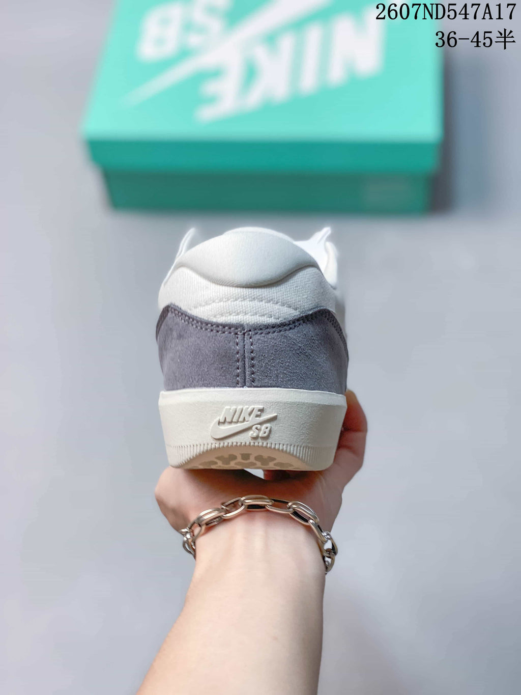 Rear view of the Nike SB Force 58 sneaker showing the grey heel panel, white collar and embossed Nike SB branding.