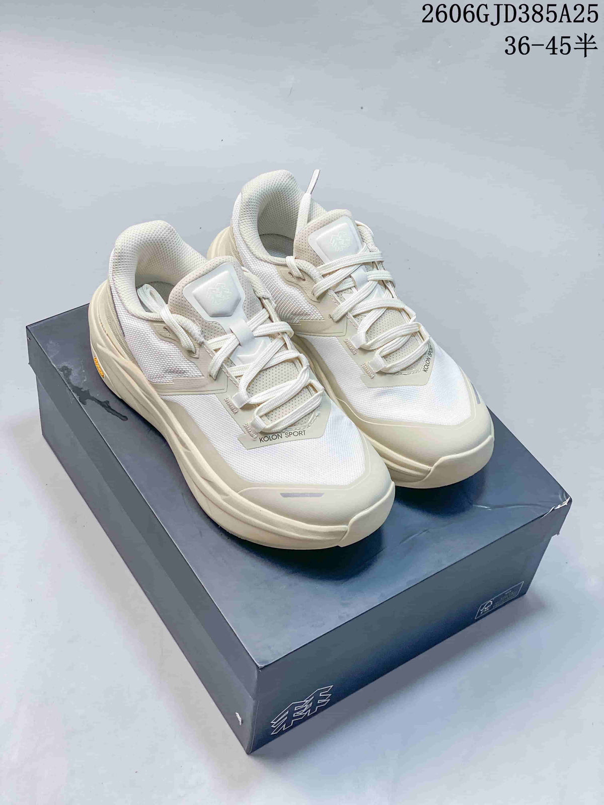 Pair of ivory Kolon Sport Voyager FT low-top hiking shoes on a box