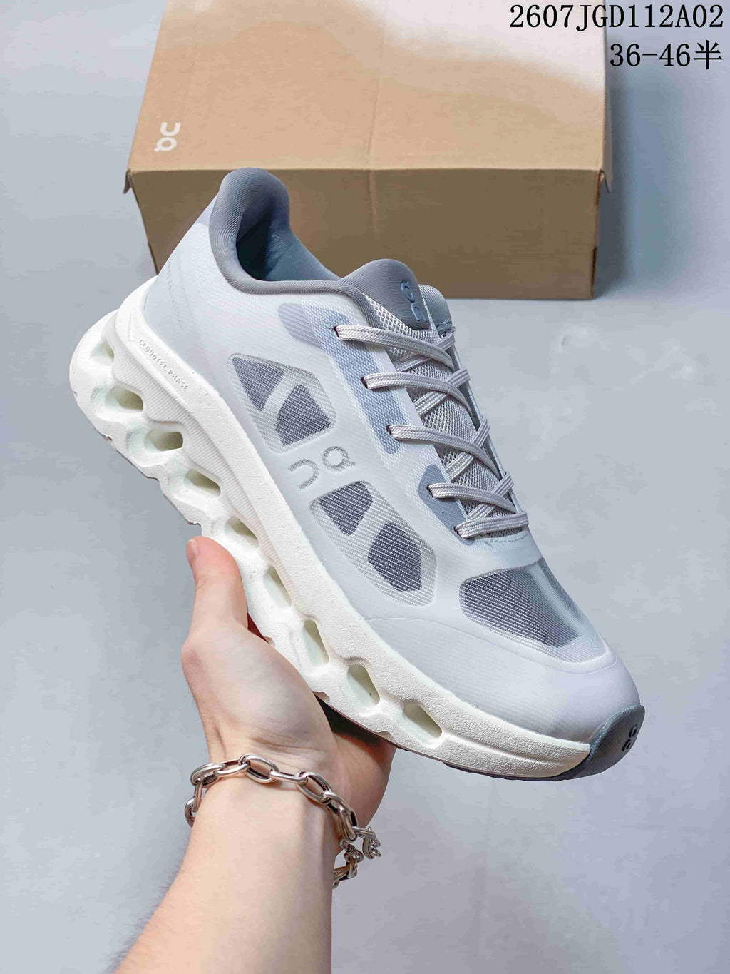 Close-up side view of a light grey Cloudtilt Remix sneaker with a white sculpted sole