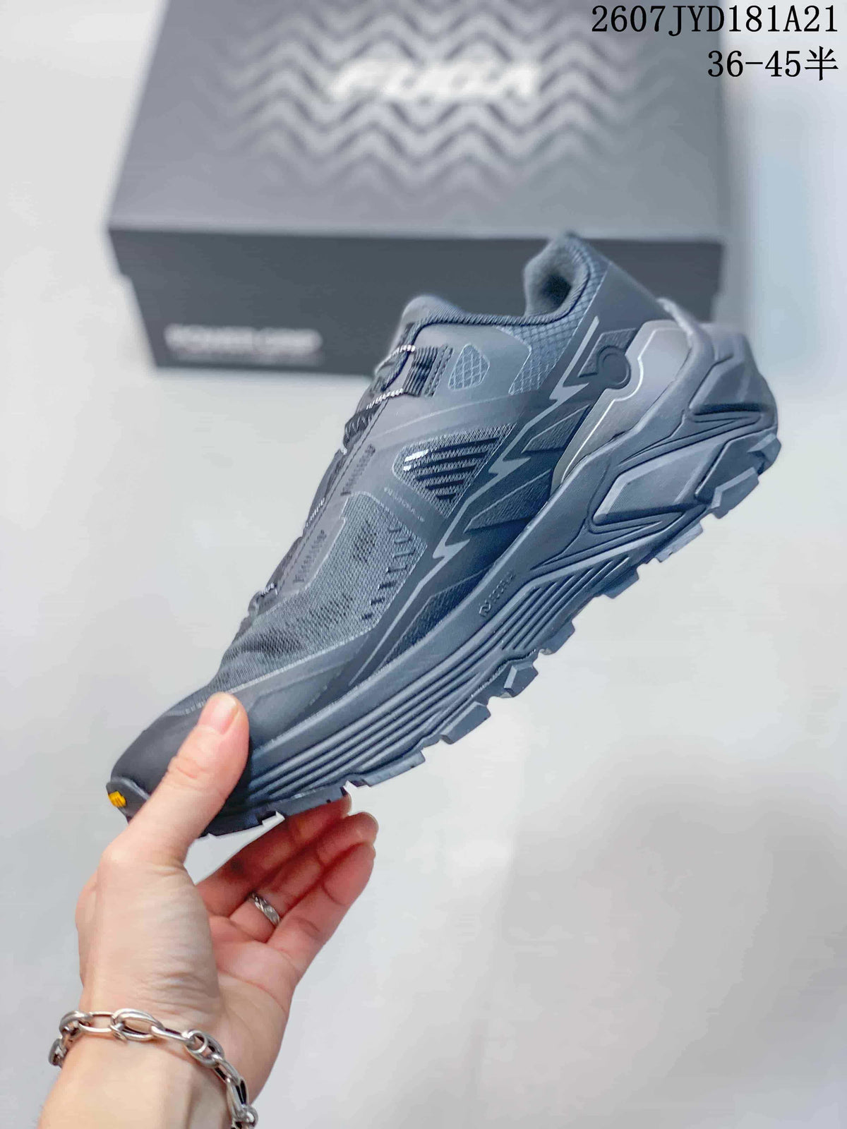 Side profile of the Kailas trail running shoe showing layered upper panels, reflective-style detailing and a lugged sole.