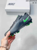 Side view showing the textured black upper, green Swoosh accent, low-cut collar, and studded sole.
