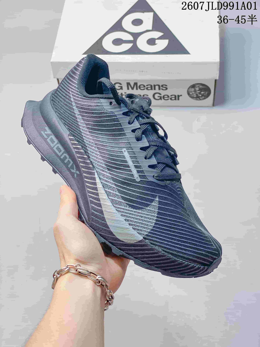 Side view of a charcoal gray Nike ACG trail shoe