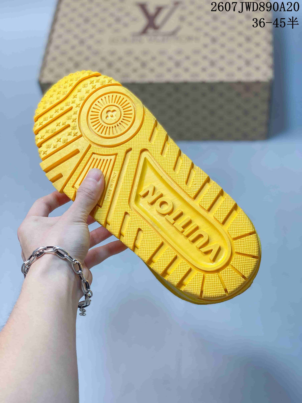 Close-up of the yellow sneaker outsole showing a patterned rubber tread and central Louis Vuitton branding.
