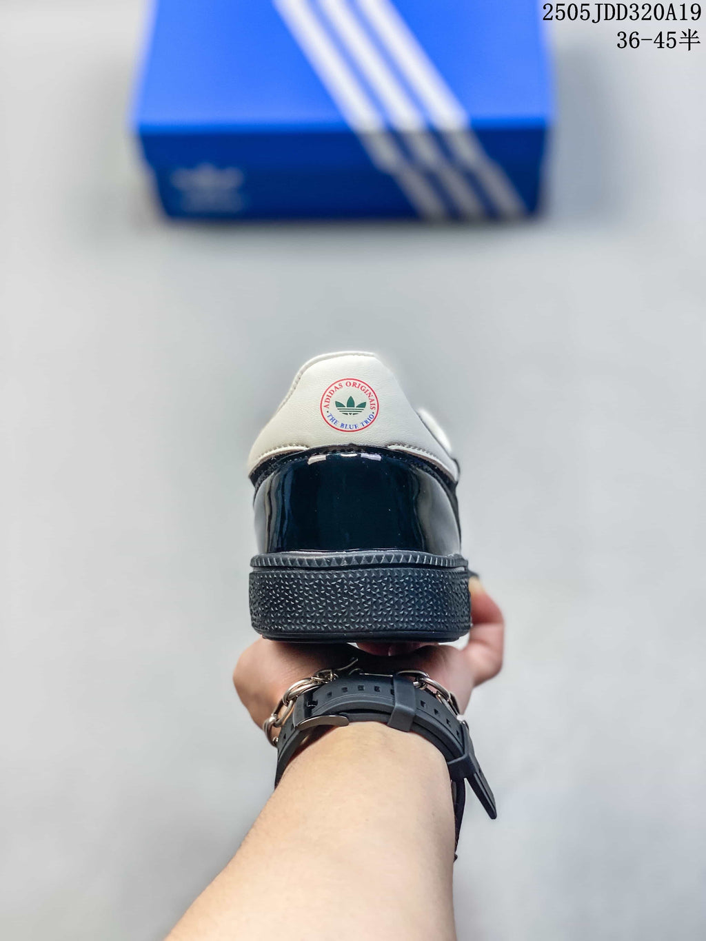 Rear view of the sneaker showing the glossy black heel panel, white collar and textured outsole.