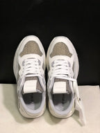 Top view showing white laces, grey textured panels and padded collars.