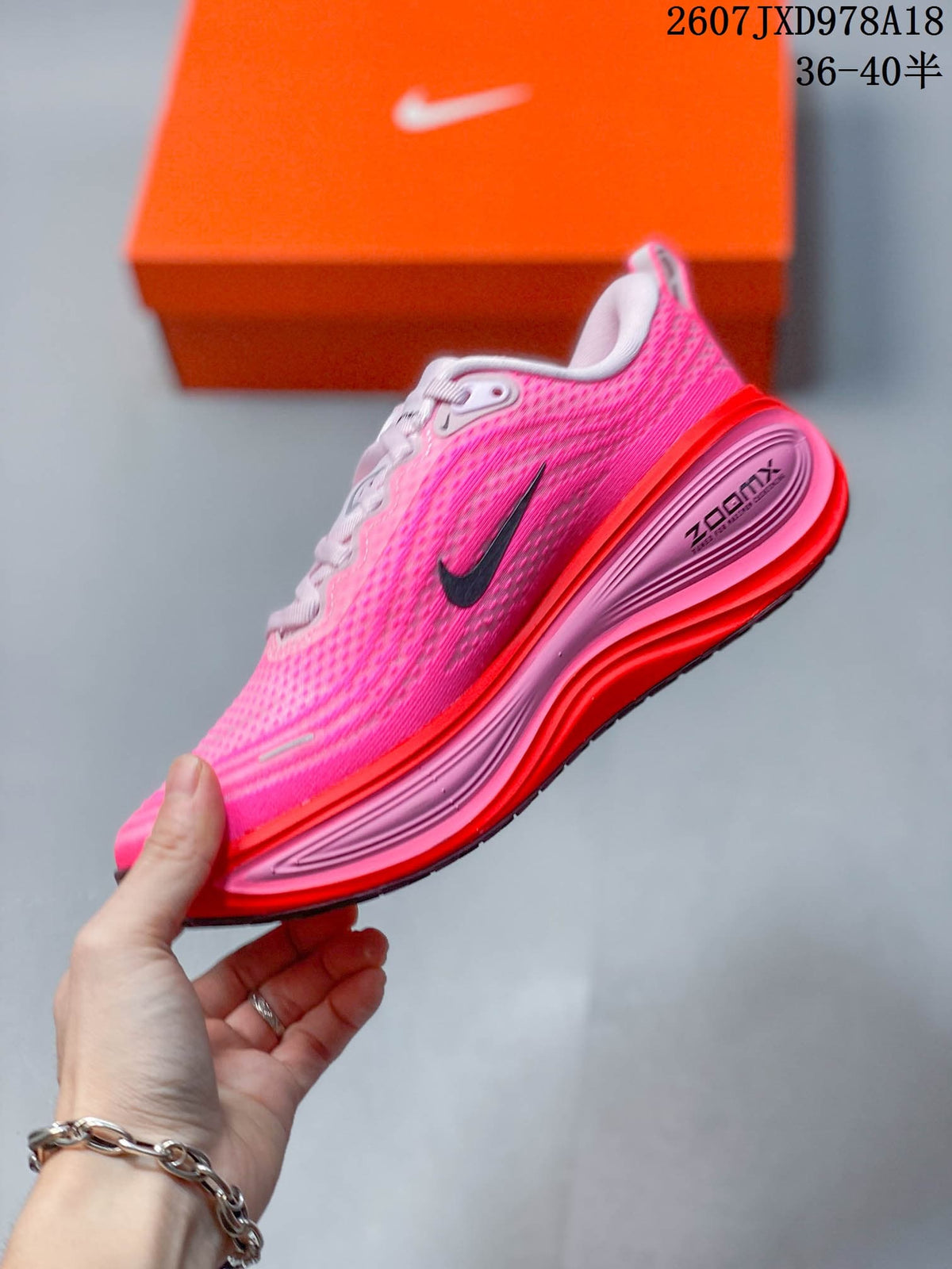Side profile of the pink and red sneaker showing the Nike Swoosh, sculpted midsole and visible ZoomX branding.