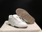 Angled product view with one sneaker lifted to show the textured rubber outsole and tread pattern.