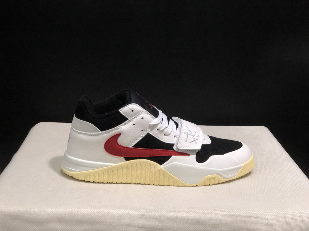 Close side view showing the white and black upper, red side branding, and cream-colored outsole.