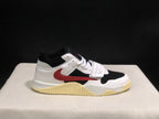 Close side view showing the white and black upper, red side branding, and cream-colored outsole.