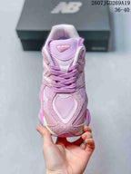 Front view showing the 9060 tongue marking, layered toe panels, laces, and mesh detailing.