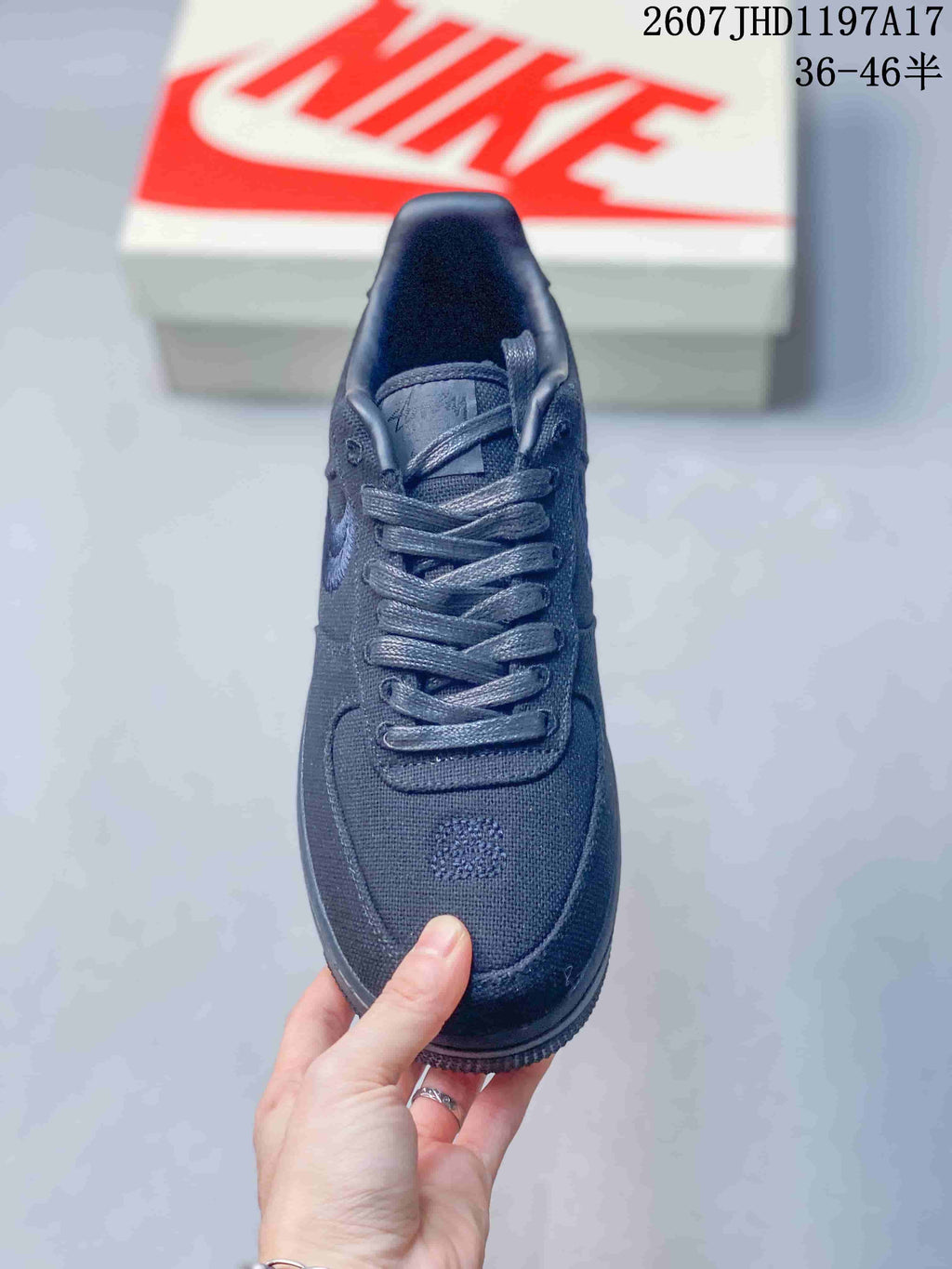 Top view of the black sneaker showing tonal laces, padded tongue, textured toe box and embroidered forefoot detail.