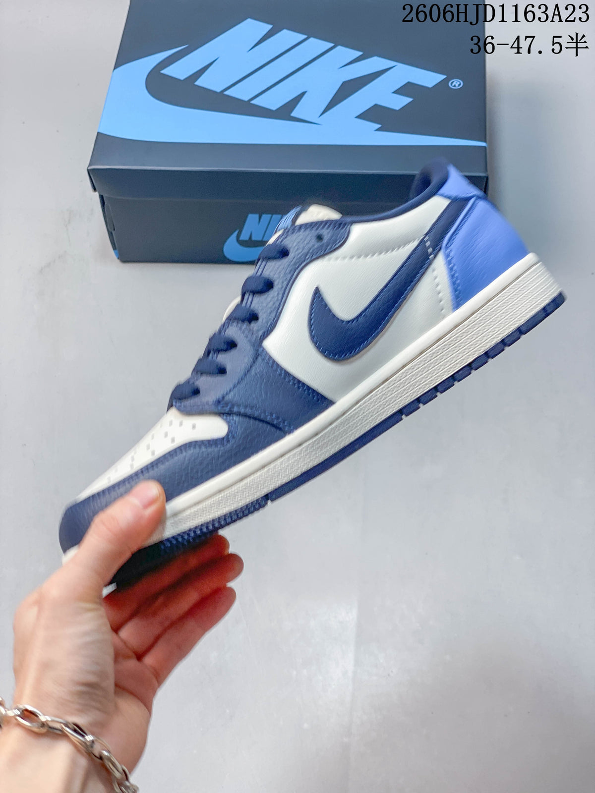 Side view of a blue and white Jordan Air Jordan 1 Low sneaker