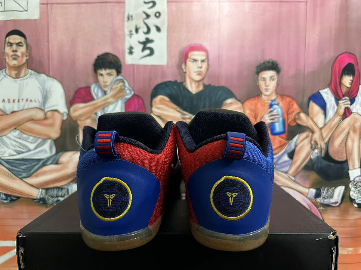 Rear view of navy, blue and red basketball shoes with heel emblems and translucent brown-toned outsoles.