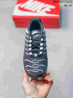 Front view of the black and white low-top sneaker showing the lace-up closure, padded tongue, and curved toe-box detailing.