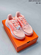 Pair of pale pink and coral Nike sneakers displayed on an orange shoebox; overlay text shows style code 2607JXY521A21 and sizes 36–40.