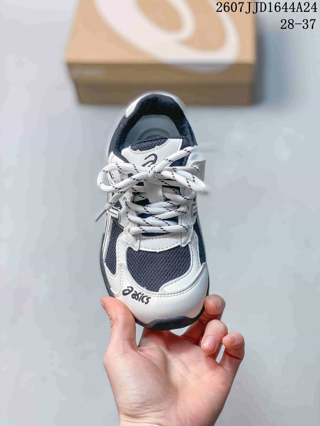 Top view of an ASICS HYPERSYNC kids’ sneaker showing the laces, tongue and contrasting toe panels.